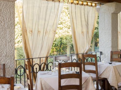 a dining room with tables and chairs and a window at Gran Osteria Tre Noci in Sistiana