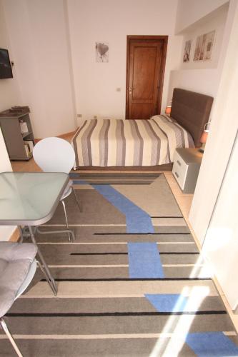 a room with a bed and a rug on the floor at B&B Villa Elisa in Bosa