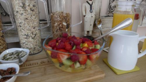 a bowl of fruit on a counter with a bowl of cereal at Marmalade Bed & Breakfast in Torquay