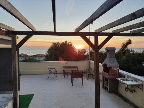 a patio with a fireplace and a table and chairs at Villa Capriccio in Villaggio San Leonardo