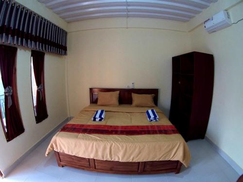 Ένα ή περισσότερα κρεβάτια σε δωμάτιο στο Golo Tango Homestay