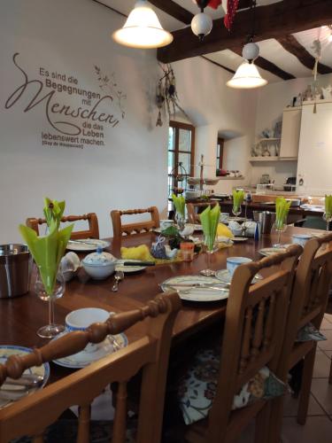 a dining room with a wooden table and chairs at Gutsherrenhaus in Maikammer