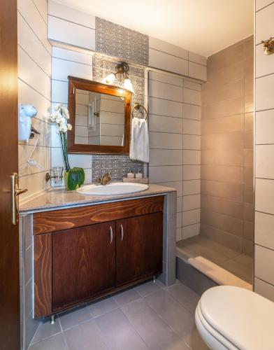 a bathroom with a sink and a shower at Paralia Beach Boutique Hotel in Paralia Katerinis