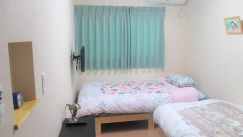 a bedroom with two beds and a window at kyowara Tenjin / Vacation STAY 6821 in Kyoto