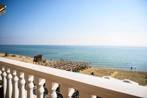 a view of a beach with umbrellas and the ocean at Anastasios Room's in Olympiaki Akti