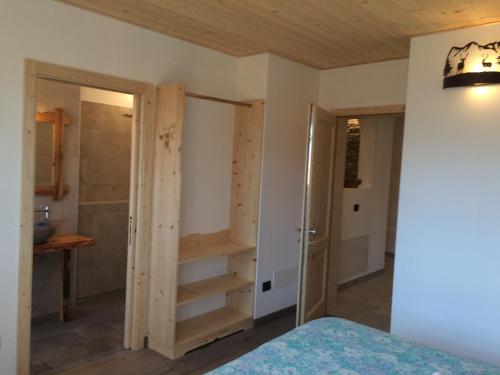 a bedroom with a closet and a walk in shower at B&B da Erica in Comano Terme