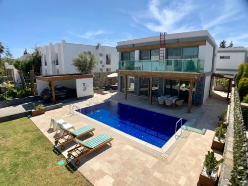 a house with a swimming pool in front of a house at Ultra Luxury Private Villa with Swimming Pool in Bodrum City