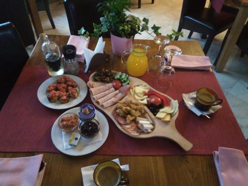 a table with plates of food on a table at Vila Dracula in Căpăţîneni-Pămînteni