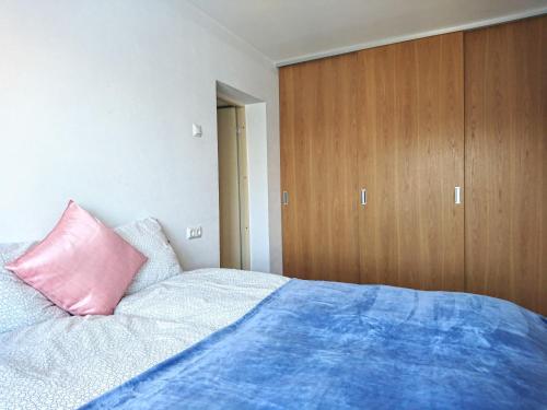 - une chambre avec un lit et un oreiller rose dans l'établissement City center Raua apartment with balcony, à Tallinn