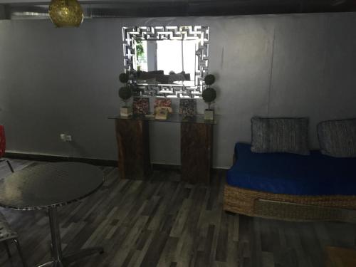 a room with a bed and a table and a window at SERENADE Lodging Rooms in Panama City