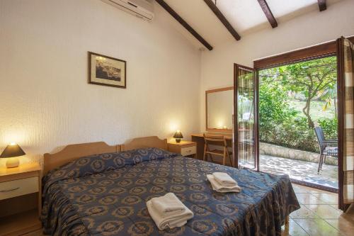 מיטה או מיטות בחדר ב-Mugeba Club Residence