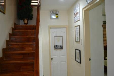 a hallway with a white door and a staircase at Fully Furnished Villa Near Clark in Mabiga, Mabalacat City in Mabalacat