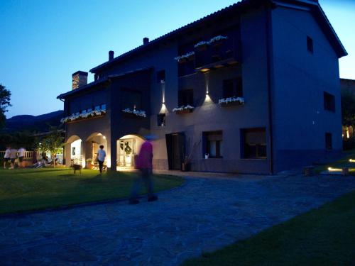 a man walking in front of a building at La Pomera in Vilaller