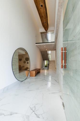 a mirror in the middle of a room with a marble floor at Riva Playasur 405 in Playa del Carmen
