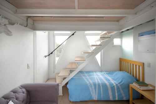 a bedroom with a bed and a stair case at Casa Azul for groups since 4 till 30 persons in Mexico City