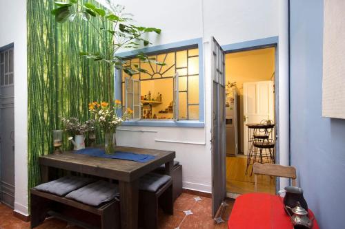 a dining room with a table with flowers on it at Casa Azul for groups since 4 till 30 persons in Mexico City