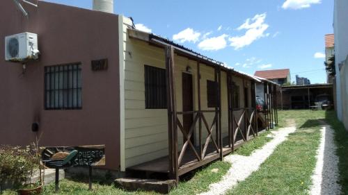 a house with a porch on the side of it at Cabañas Puerto Surf in Mar del Plata