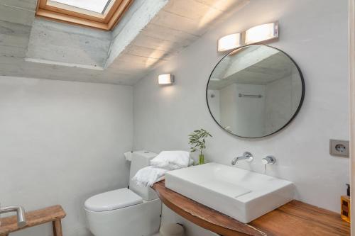 a bathroom with a white sink and a mirror at Las Azadas in Tezanos