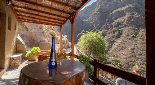 a bottle of wine sitting on a table on a balcony at Casas rurales de Guayadeque in Ingenio
