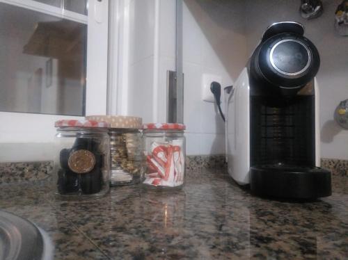 a kitchen counter with jars of food and a coffee maker at Casa Vaz 2 in Grândola