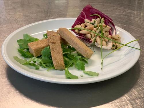 a plate of food with a salad and bread at Villa Liliana in Cervia
