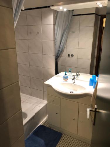 La salle de bains est pourvue d'un lavabo, d'une douche et d'une baignoire. dans l'établissement Fewo SH4, à Goslar