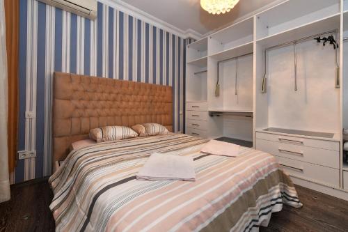 a bedroom with a large bed with two towels on it at İskete Suit in Istanbul