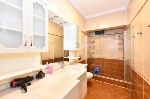 a bathroom with a sink and a shower and a toilet at İskete Suit in Istanbul