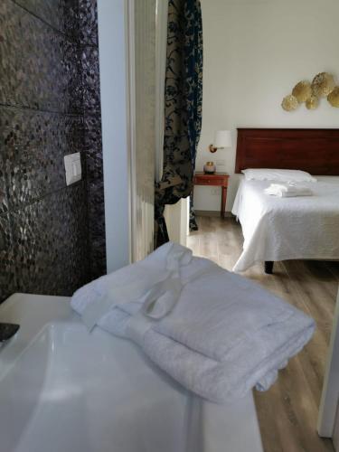 a white towel sitting on a table in a room at B&B Le Torri in Santeramo in Colle