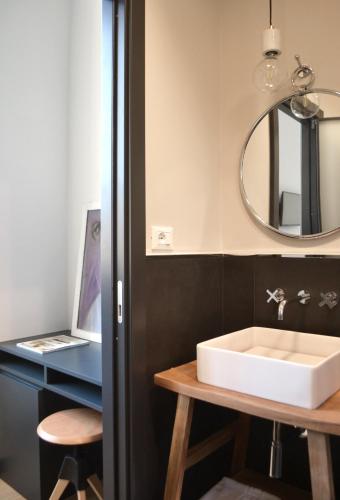a bathroom with a white sink and a mirror at Da Domè Charm Rooms in Levanto