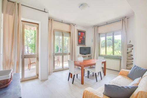 a living room with a table and a couch at Hotel Flora in Milano Marittima