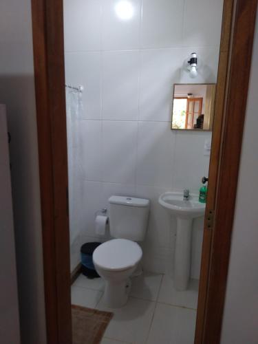 a white bathroom with a toilet and a sink at Loft da Montanha (A 8min do centro) in Nova Friburgo