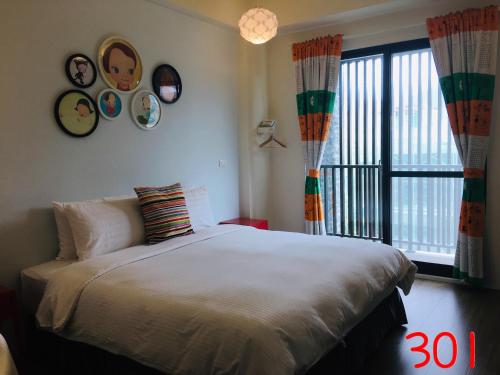 a bedroom with a bed and a large window at A-nana Cottage in Puli