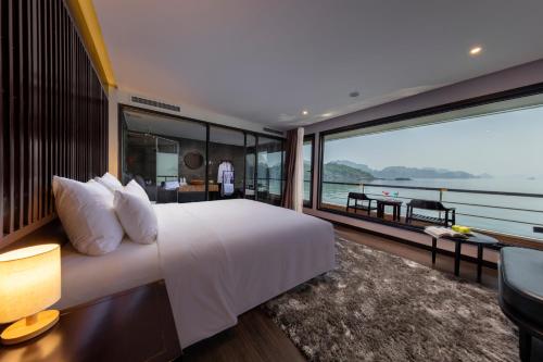a bedroom with a large white bed and a large window at Scarlet Pearl Cruises - Wonder On Lan Ha Bay in Ha Long