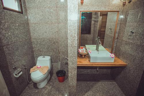 a bathroom with a toilet and a sink at Sasitara Thai Villas in Choeng Mon Beach