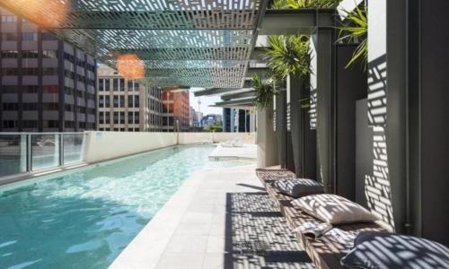 a swimming pool on the roof of a building at African Sky Retreat - Level 38 CBD Apartment with River Views in Brisbane
