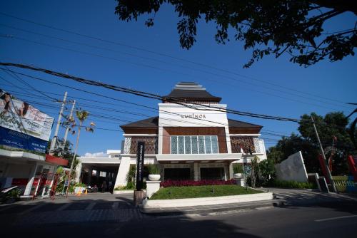 a building on the corner of a street at Luminor Hotel Banyuwangi By WH in Banyuwangi