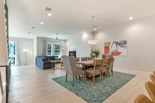 a dining room and living room with a table and chairs at Modern 4BR Townhouse in Bienville Villas in New Orleans