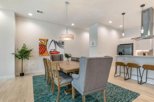 a kitchen and dining room with a table and chairs at Bienville Villas: Brand New 4BR in New Orleans