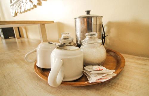 a tray with jars and a blender on a table at Pondok Kutuh Guest House in Ubud