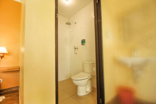 a bathroom with a toilet and a shower at Pondok Kutuh Guest House in Ubud