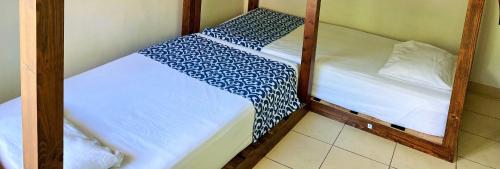 Ένα ή περισσότερα κρεβάτια σε δωμάτιο στο Hostal Casa Huasteca