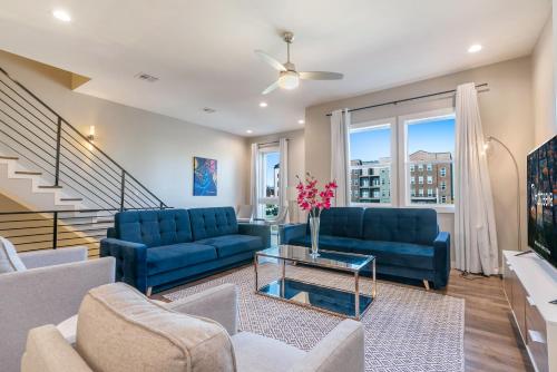 a living room with blue couches and a table at New Construction Elegant Villas in New Orleans