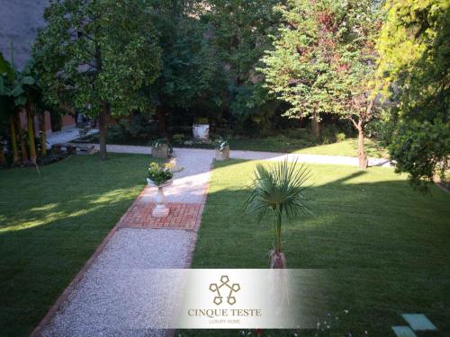 a garden with a potted plant in the grass at Cinqueteste Luxury Home in Venice