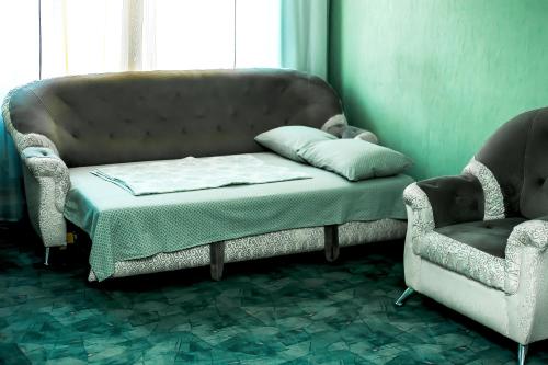 a couch and two chairs in a room at Апартаменты Кирова, 83 in Rakitnyy
