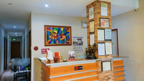 a store counter with a colorful painting on the wall at RedDoorz near Talisay District Hospital in Candulawan