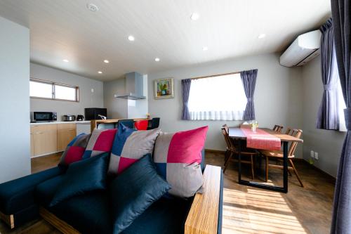 a living room with a couch and a table at 21 ORIYA Mt Fuji -縁ENISHI- in Fujikawaguchiko