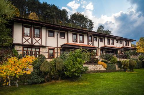 a large house with a yard in front of it at Spa Hotel Ismena in Devin