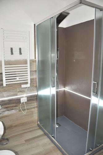 a shower with a glass door in a bathroom at R&B mediterraneo in Bosa