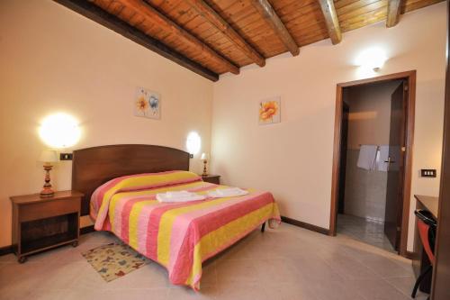 a bedroom with a bed and a walk in shower at Hotel Piccolo in Termini Imerese